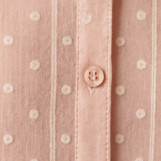 Blush pink button-down blouse with vertical stripes, dotted pattern, and long sleeves.